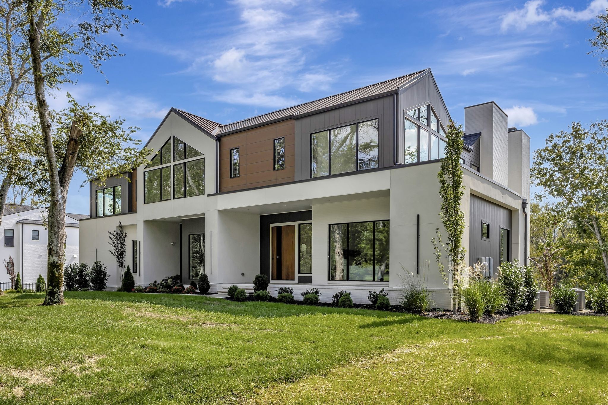 a front view of a house with a garden