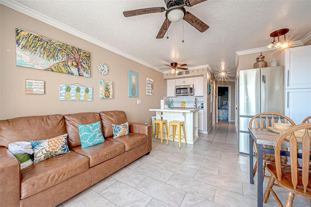 a living room with furniture and kitchen view