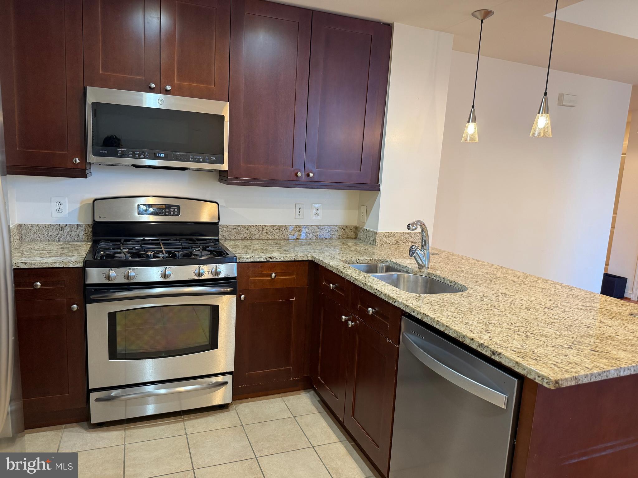 a kitchen with a sink and a stove top oven