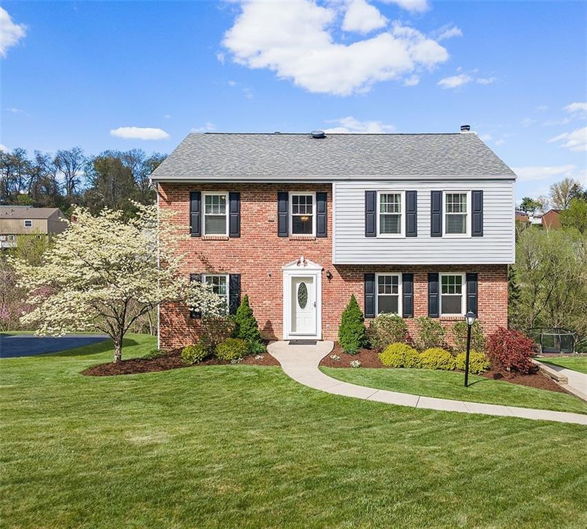 a front view of a house with a yard