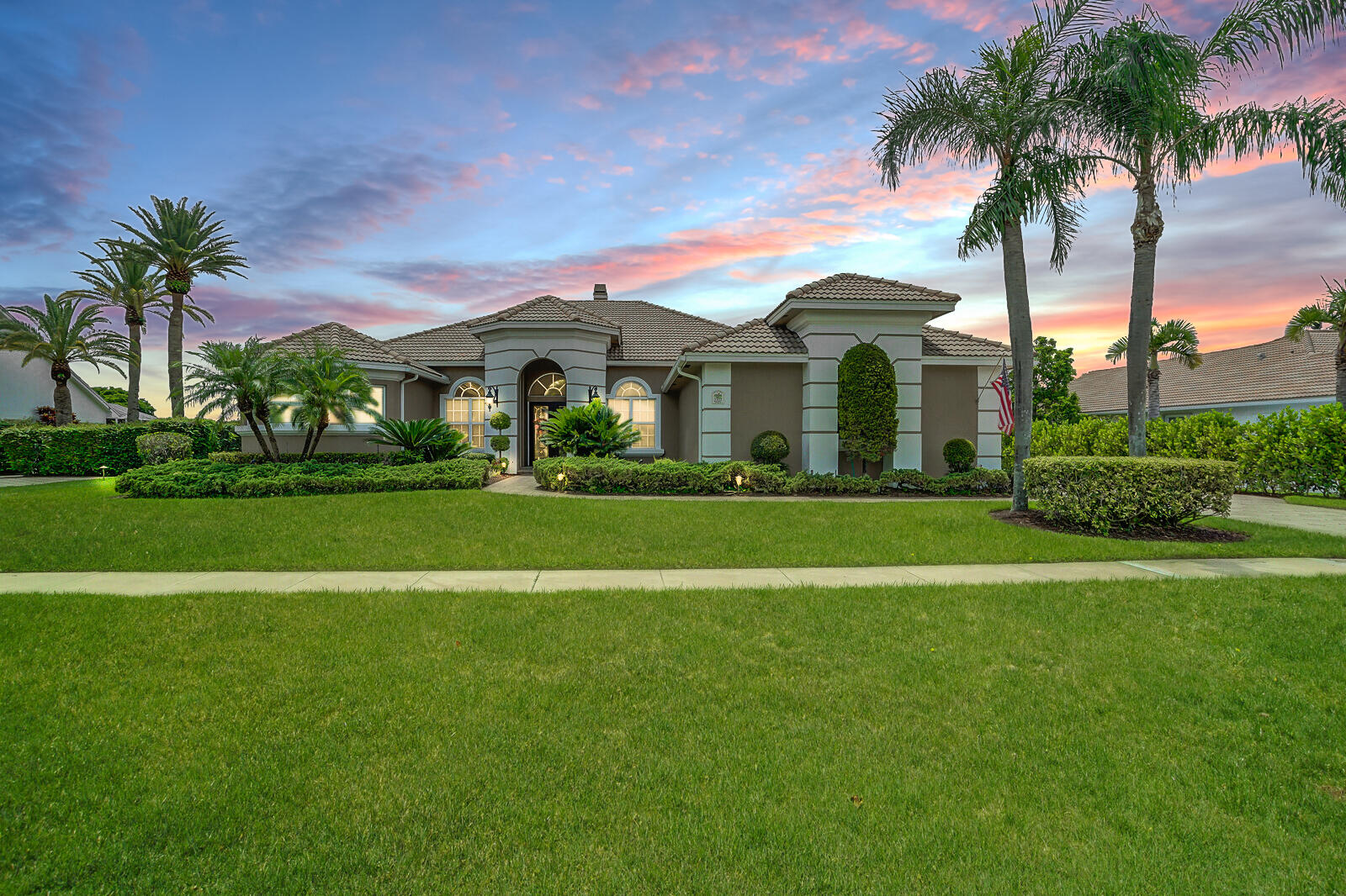 a front view of a house with a garden