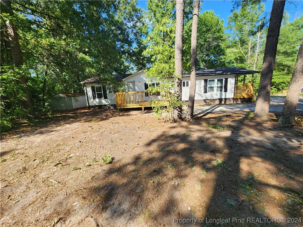 a view of a house with a tree in the yard