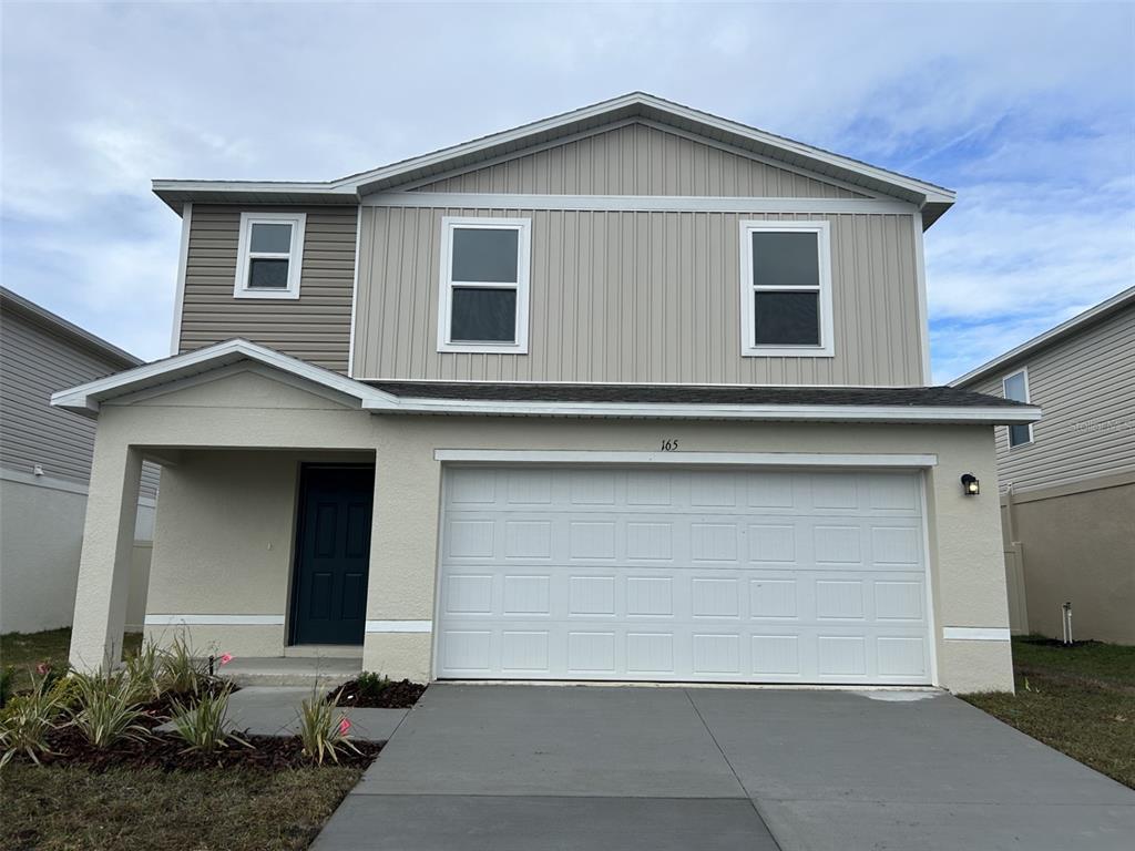 a front view of a house with garage