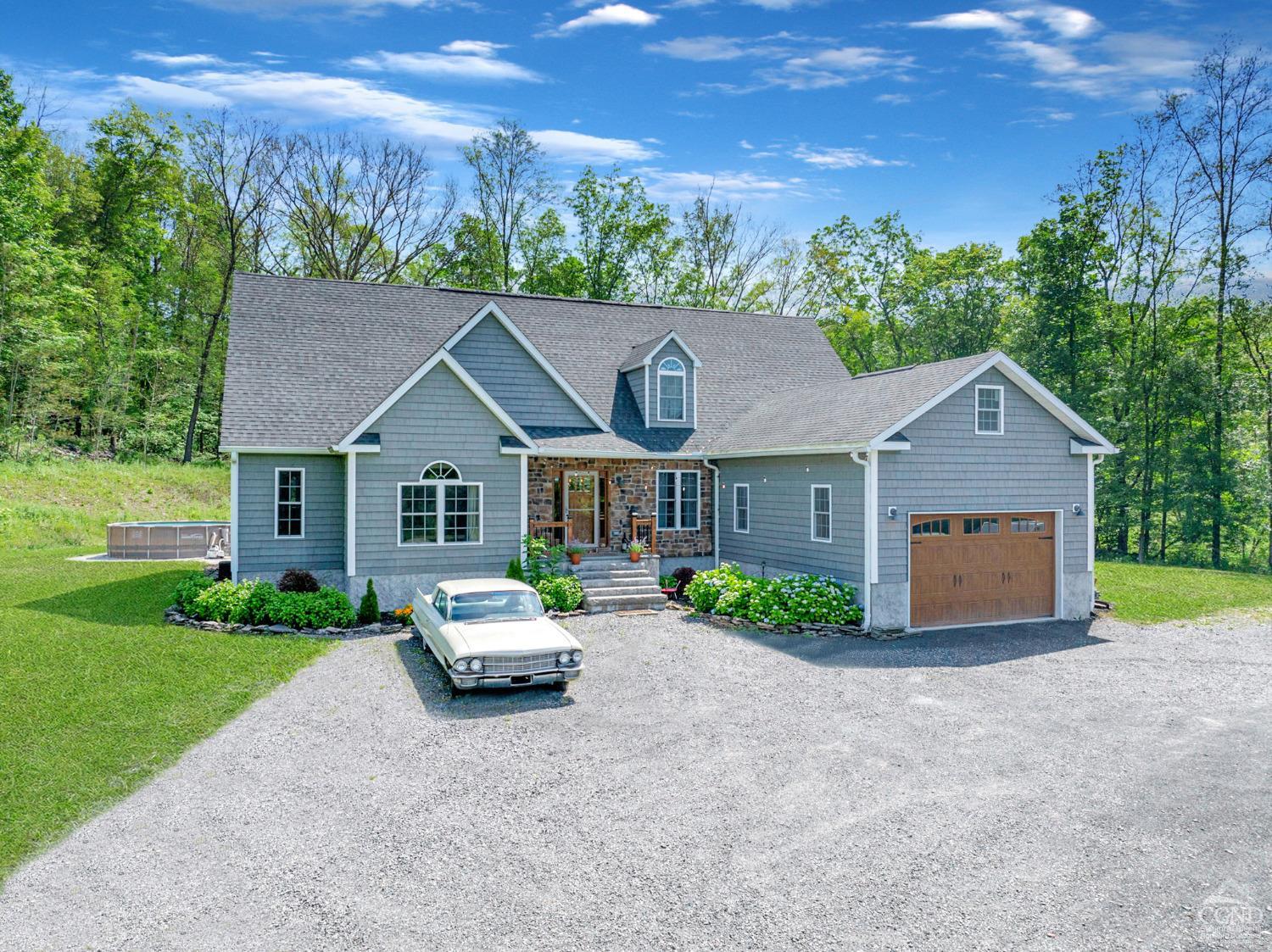 a front view of house with yard and green space