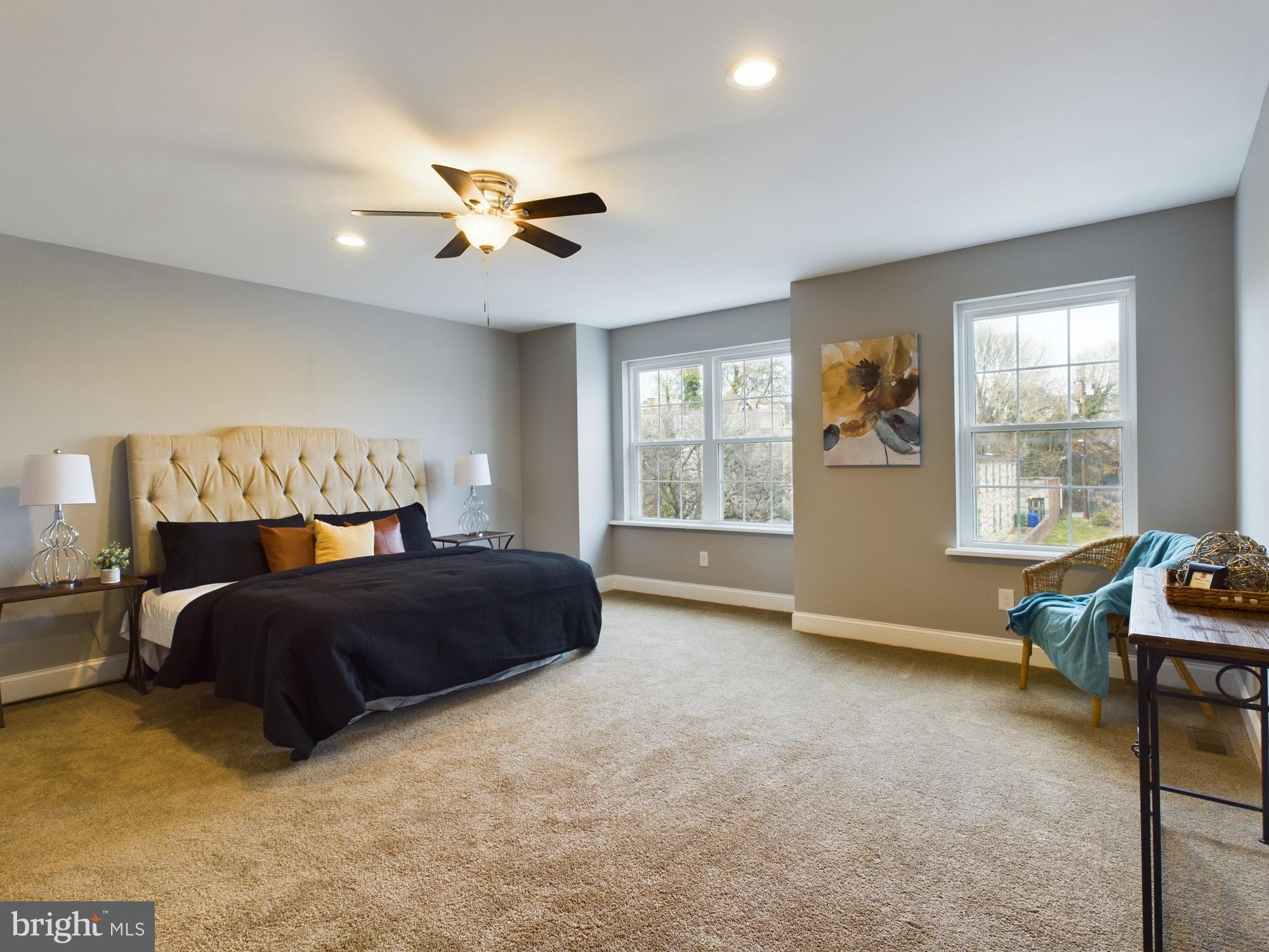 a bedroom with a large bed and a window