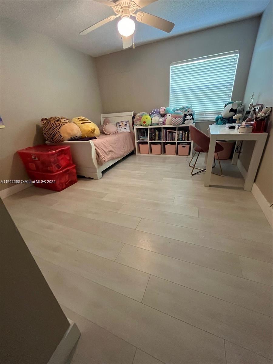 a living room with furniture a window and a projector