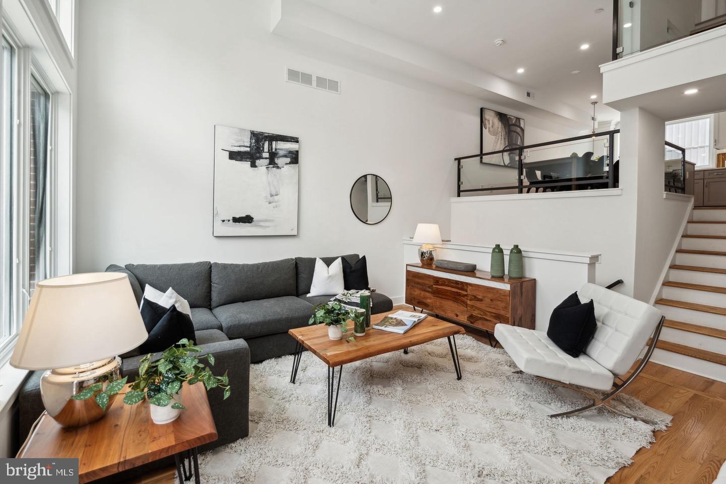 a living room with furniture and view of kitchen