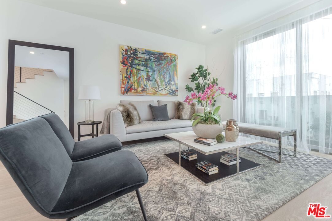 a living room with furniture and a potted plant