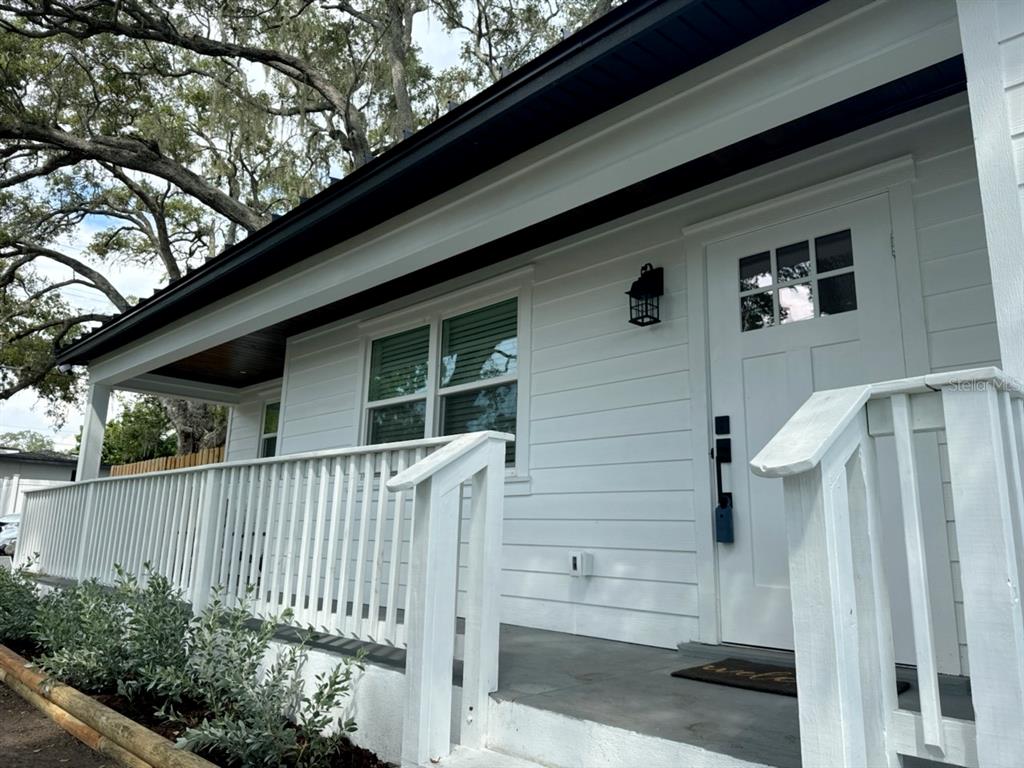 a side view of a house with a small yard