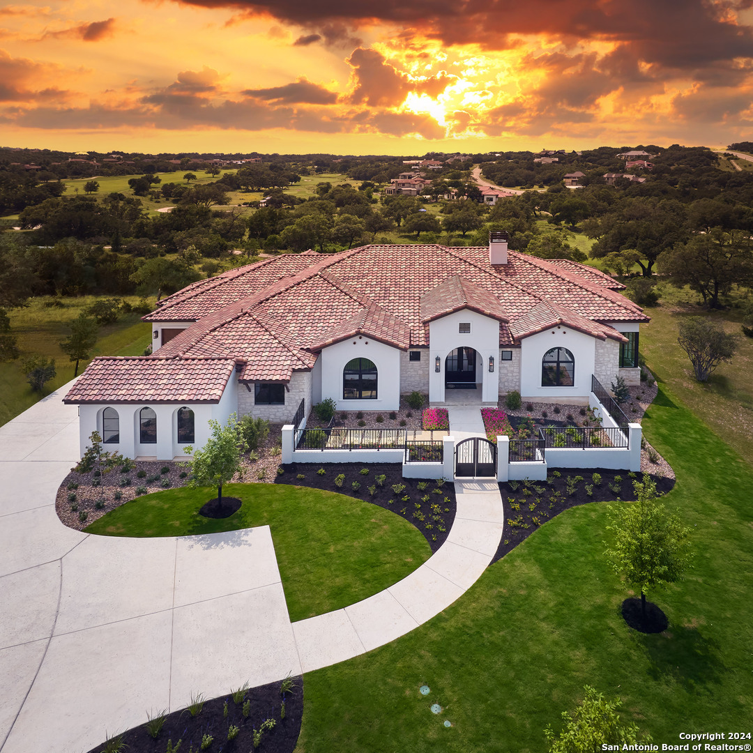 a aerial view of a house with swimming pool and a yard