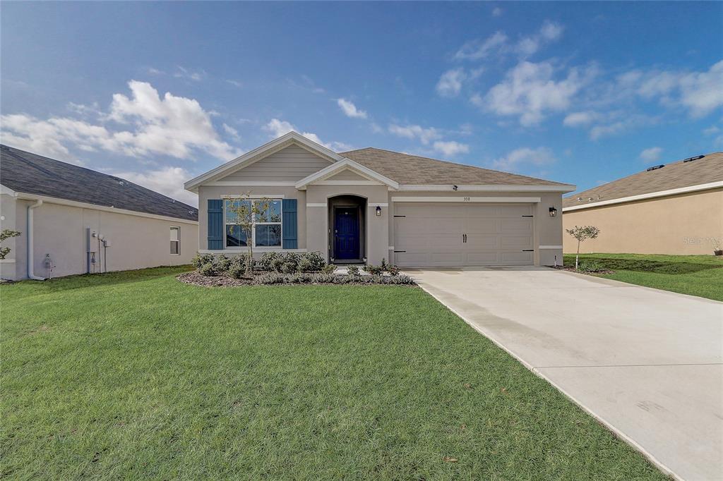 a front view of house with yard and green space