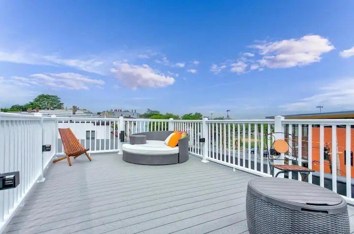 a roof deck with table and chairs