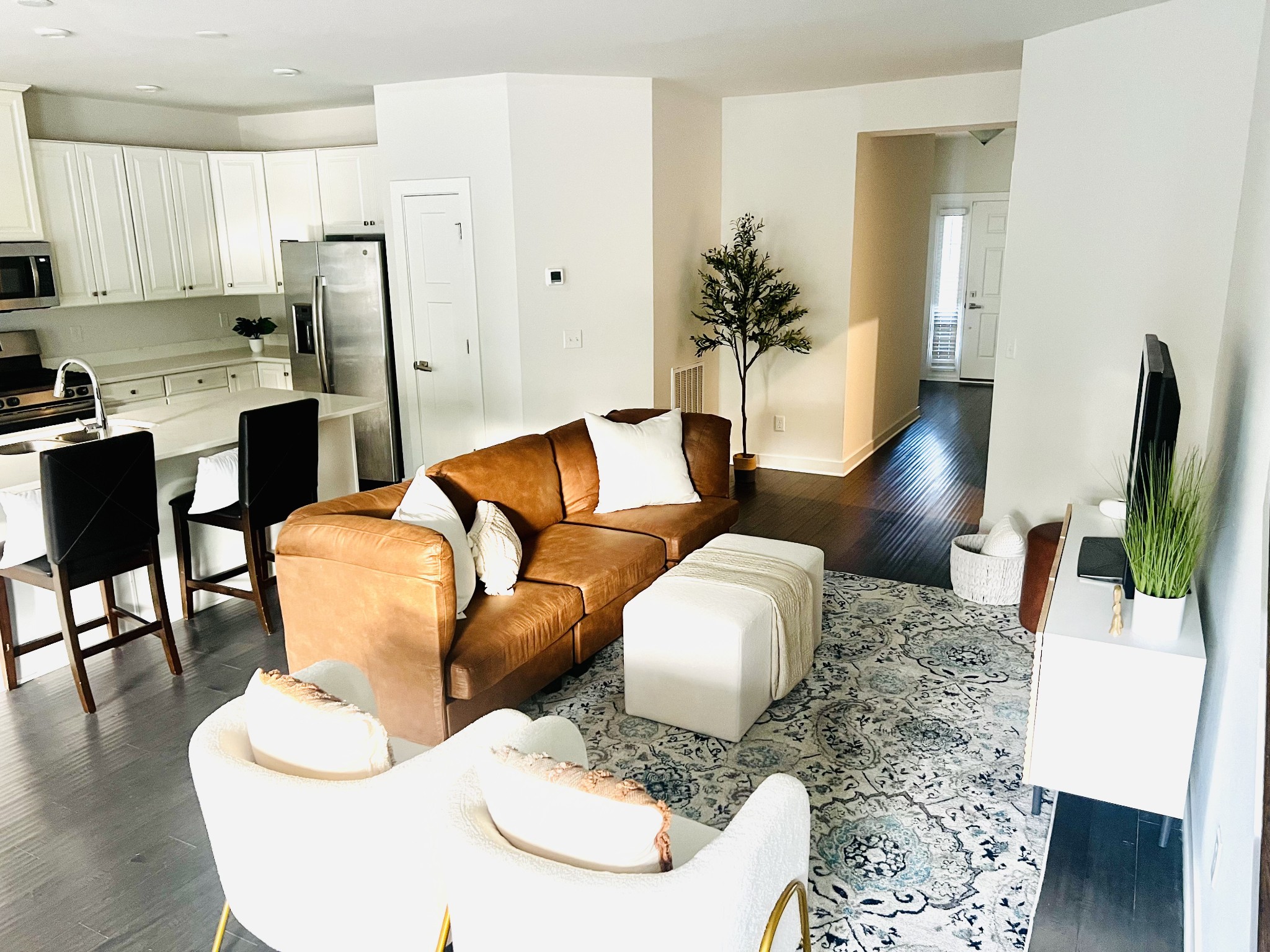 a living room with furniture and a dining table