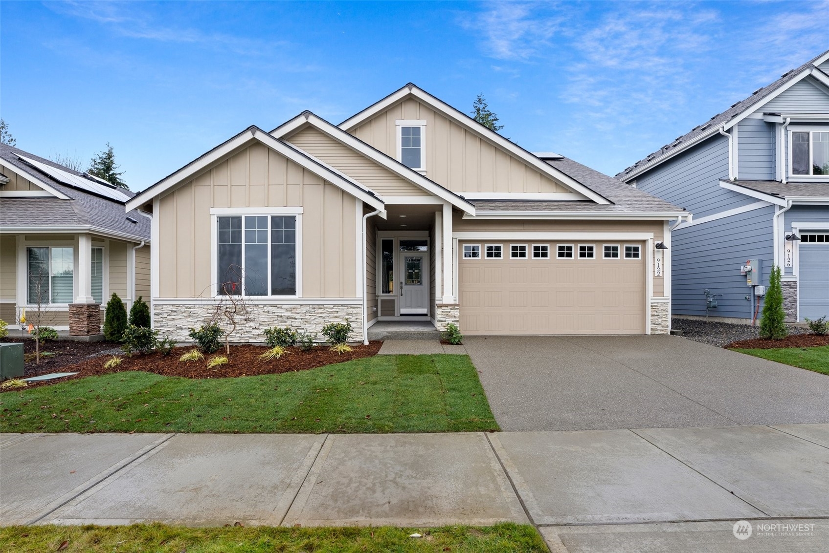 a front view of a house with a yard and garage