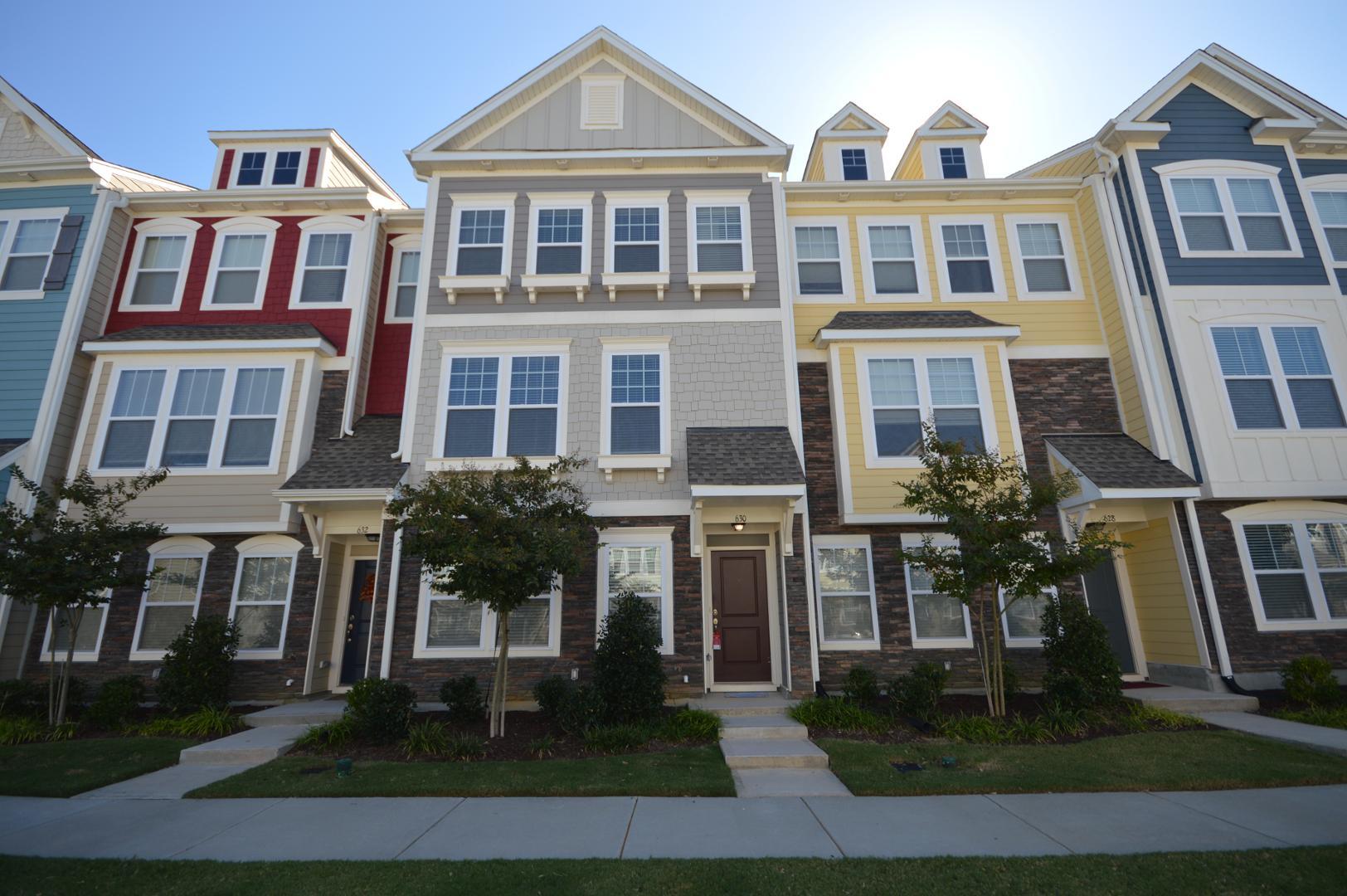 a front view of a residential apartment building with a yard