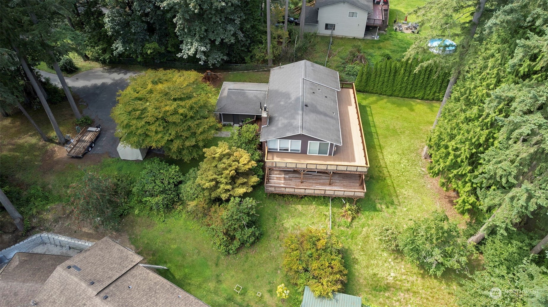 an aerial view of a house with pool garden and outdoor seating