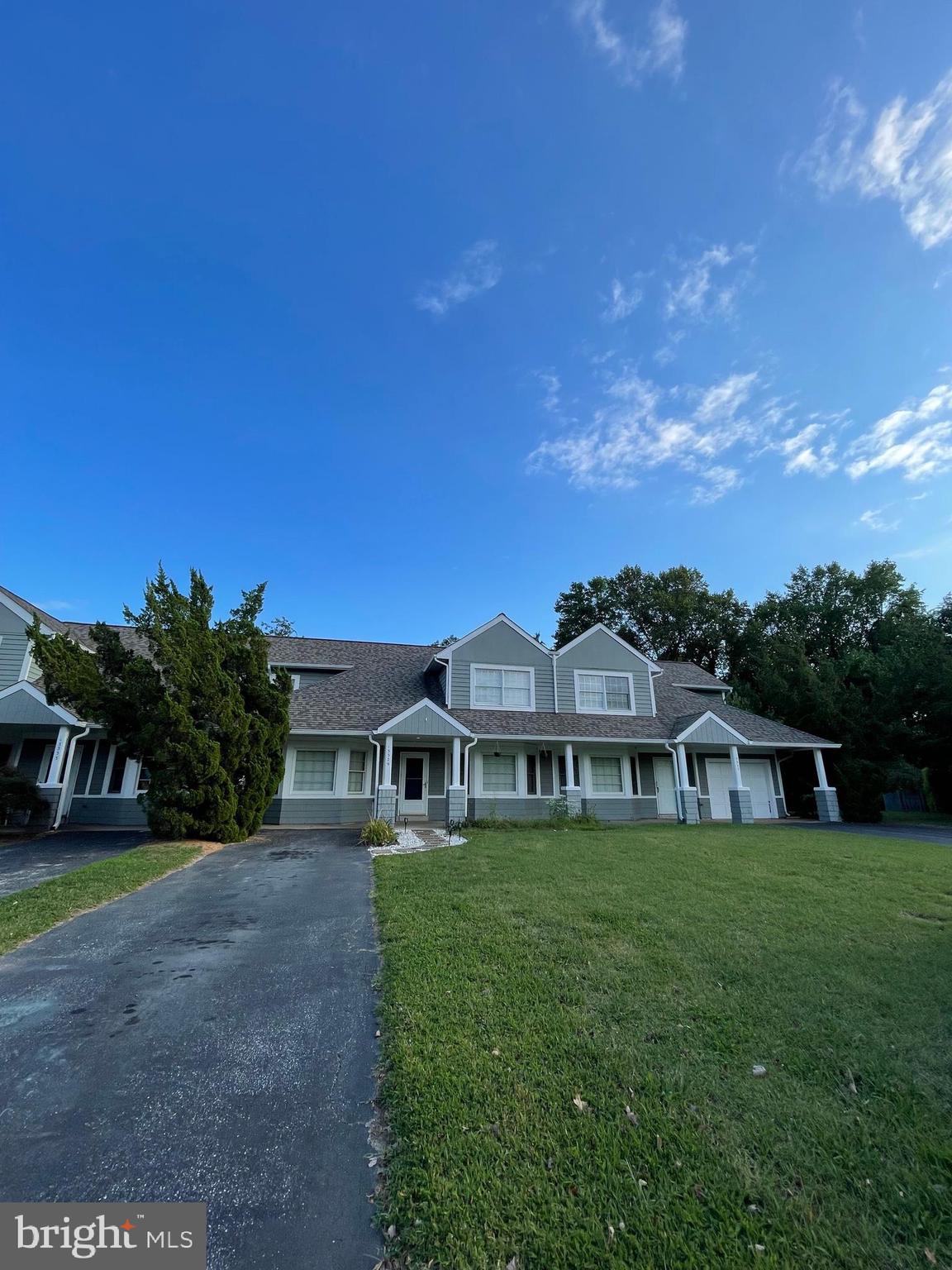 a front view of house with a garden