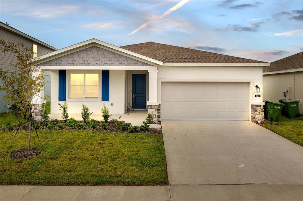 a front view of a house with garden