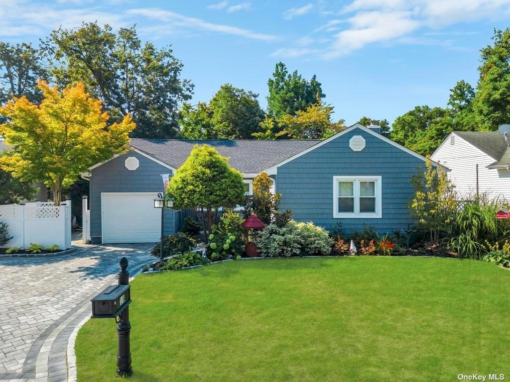 a front view of a house with a garden and plants