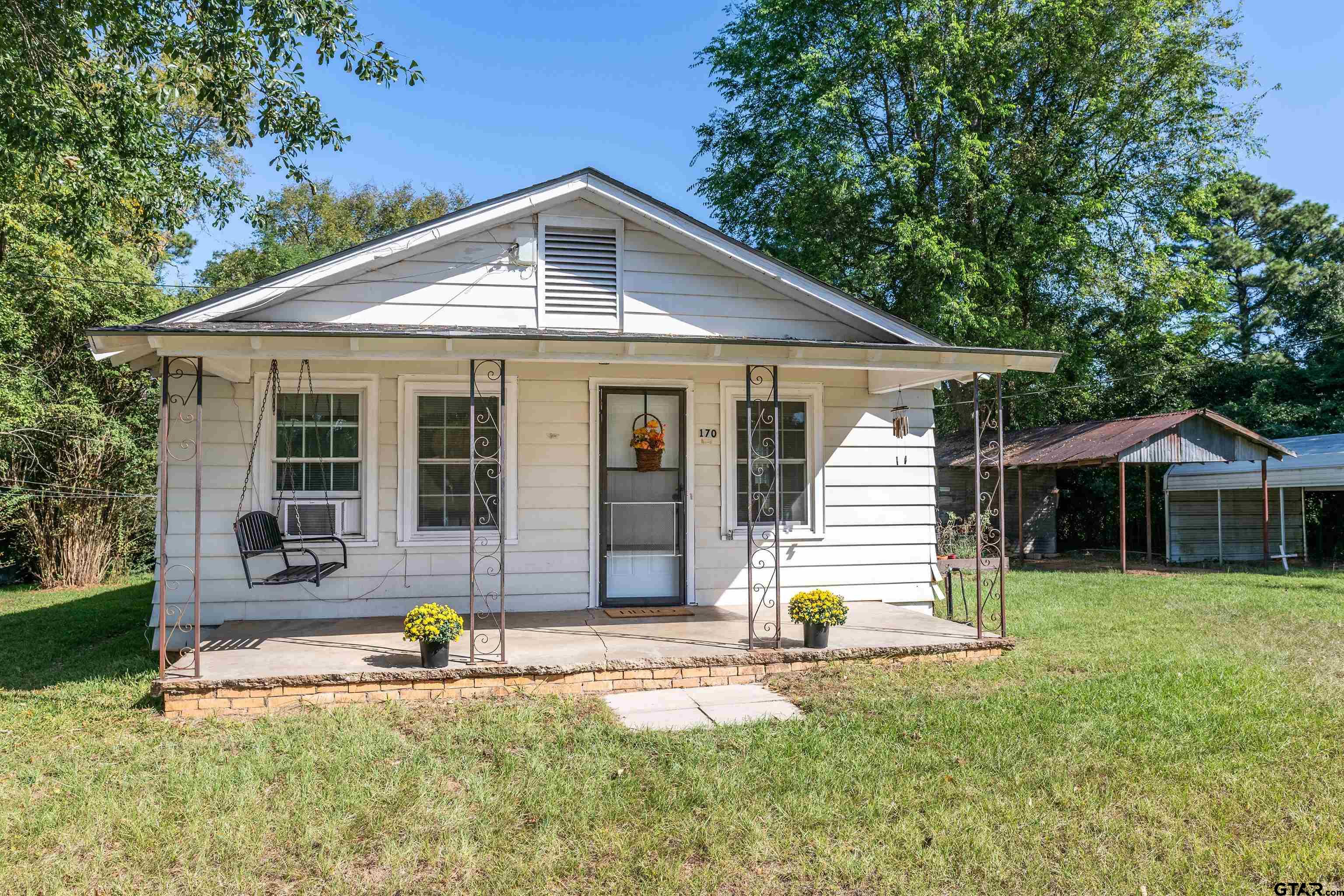 a front view of a house with a yard and porch