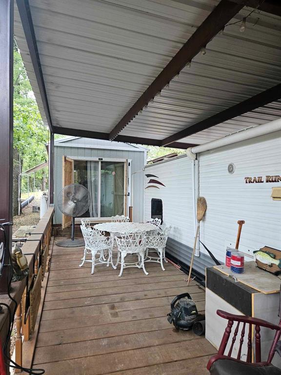 a view of a patio with table and chairs and wooden floor