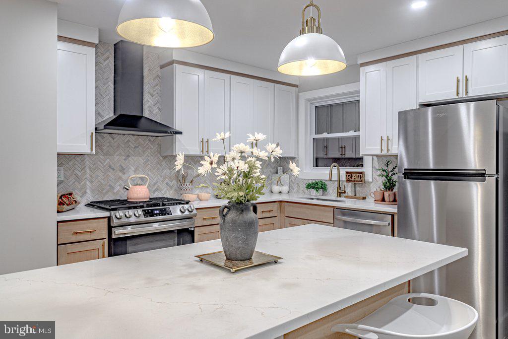 a kitchen with a refrigerator and a stove