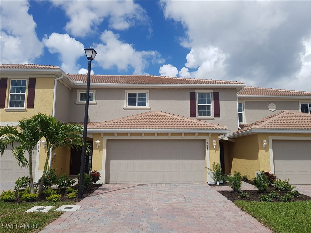 a front view of a house with a yard and garage