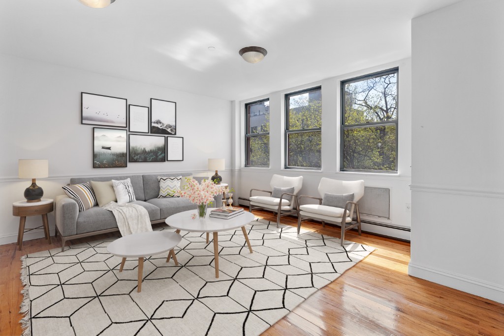 a living room with furniture and large window