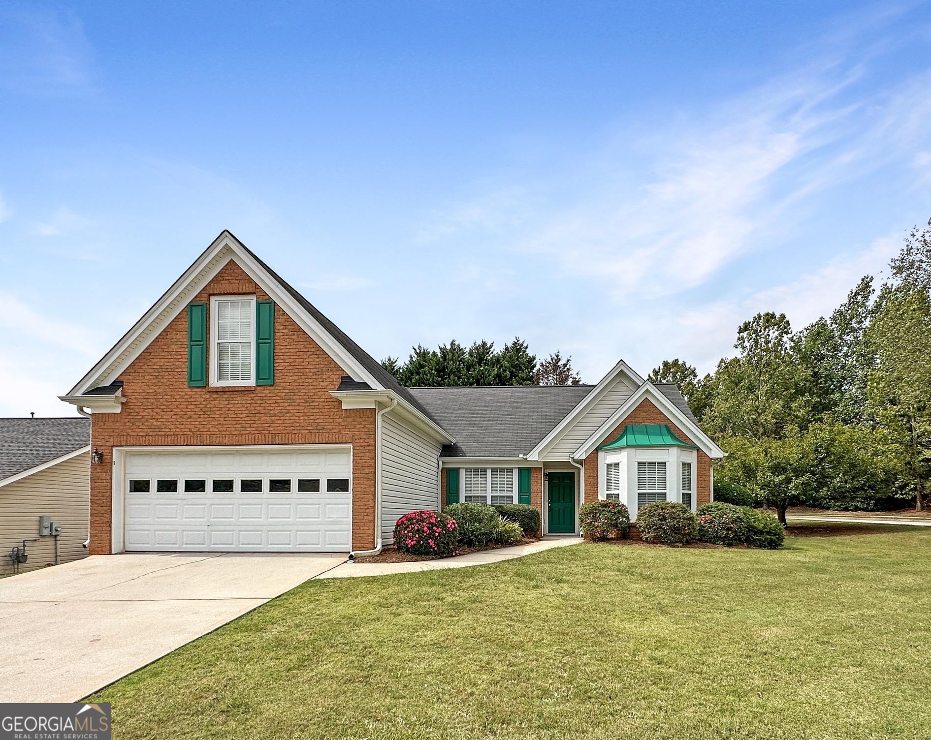 a front view of a house with yard