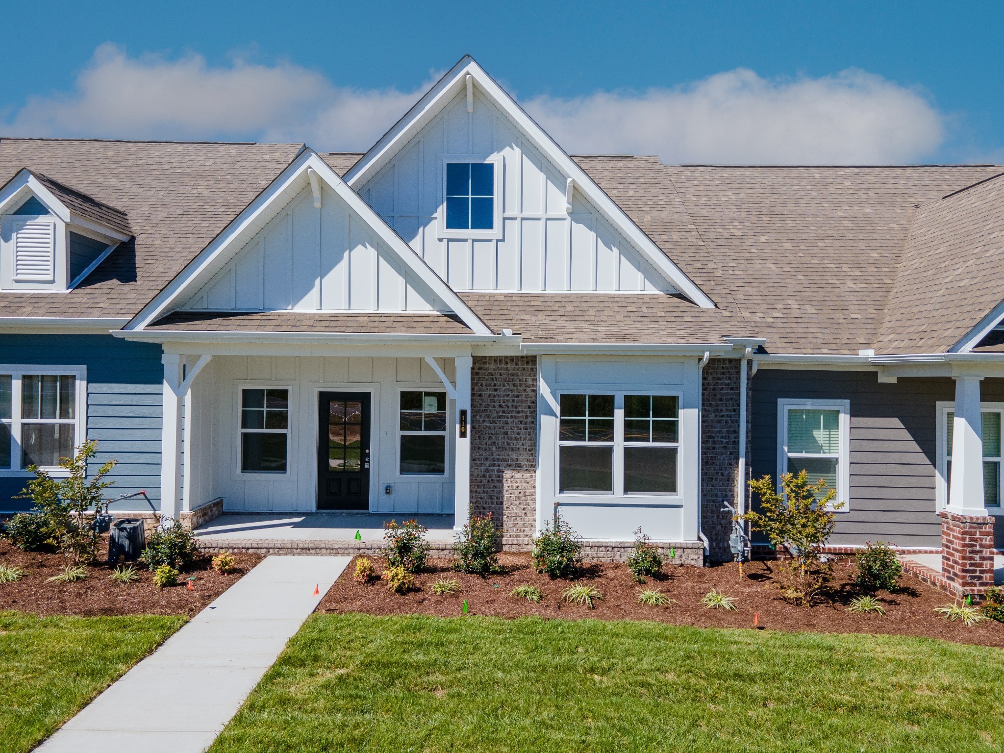 a front view of a house with yard and outdoor seating