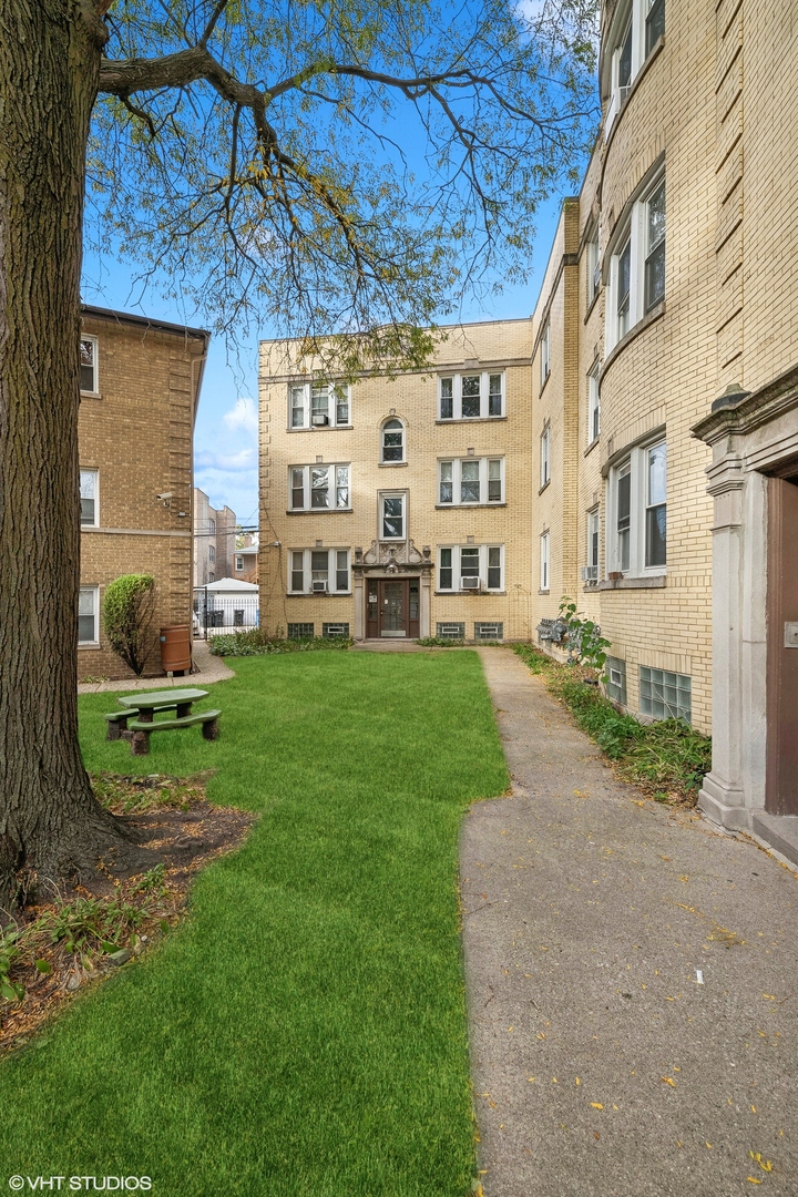 a view of a building with a yard