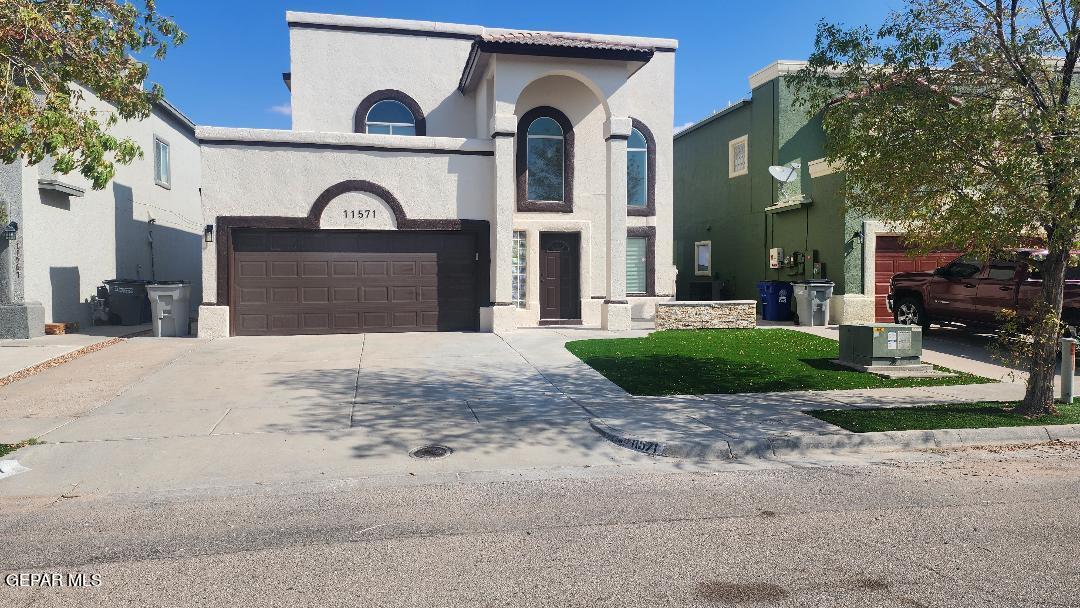 a view of a grey house with a yard