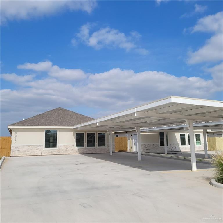 Rear view of property with a carport