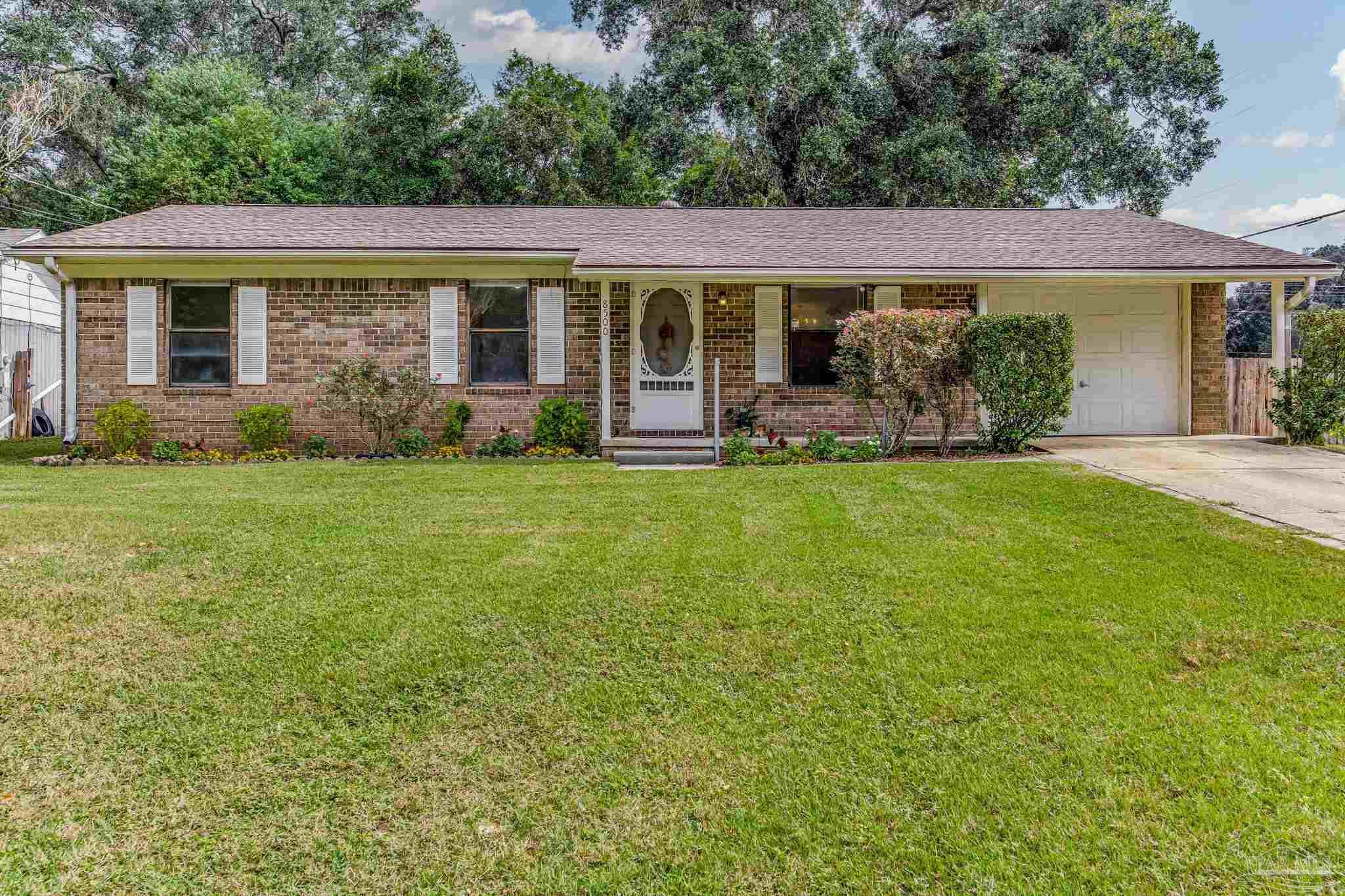 a front view of a house with a garden