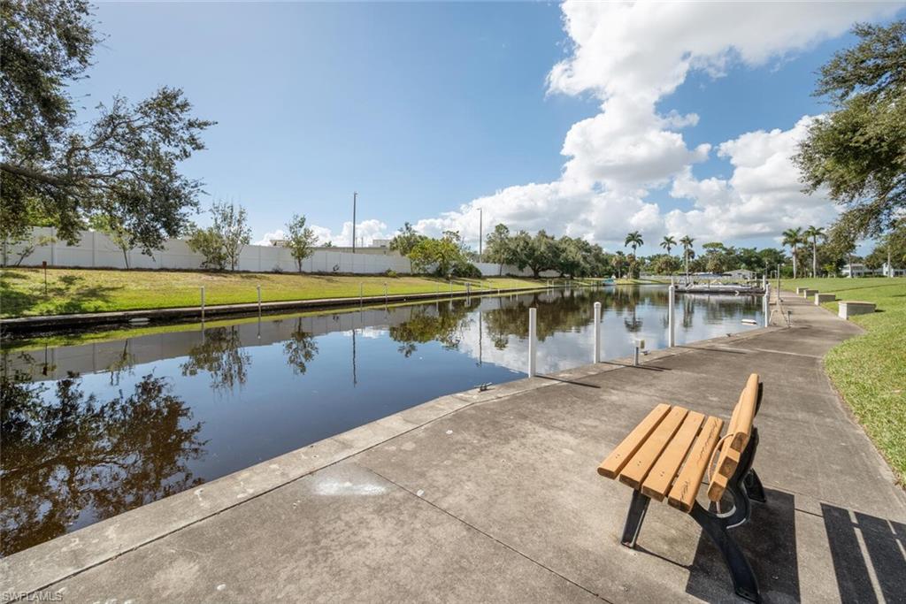 a view of a lake with table and chairs