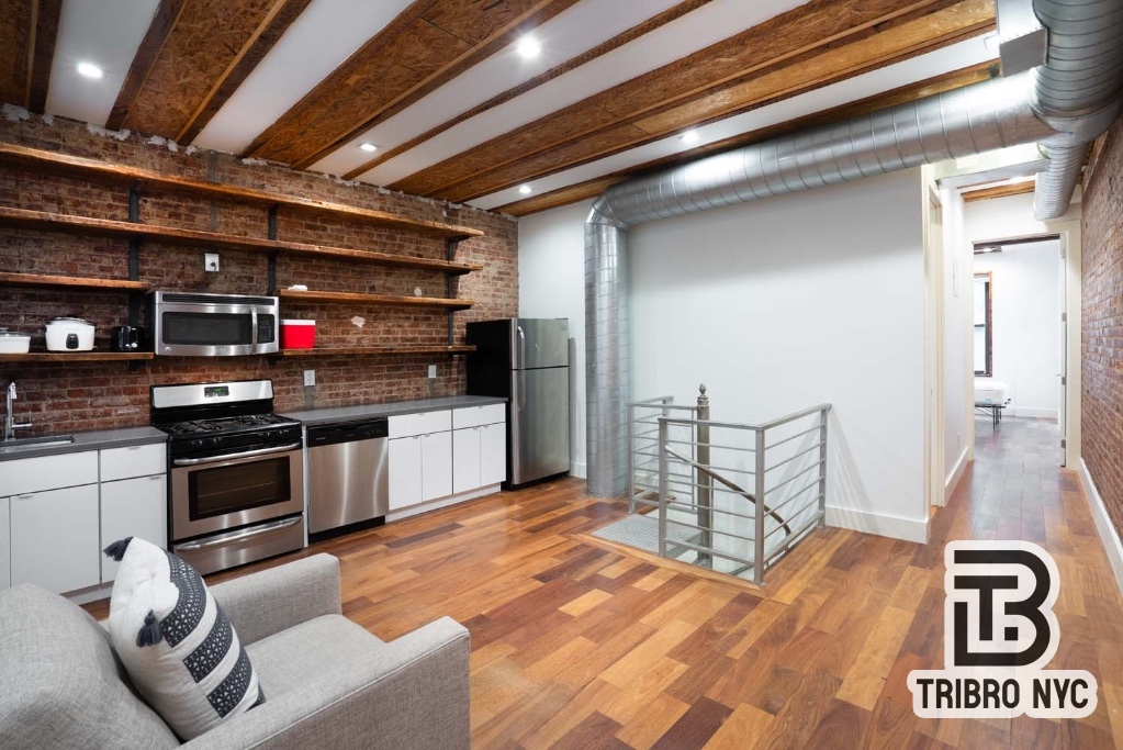 a kitchen with granite countertop a stove and a refrigerator