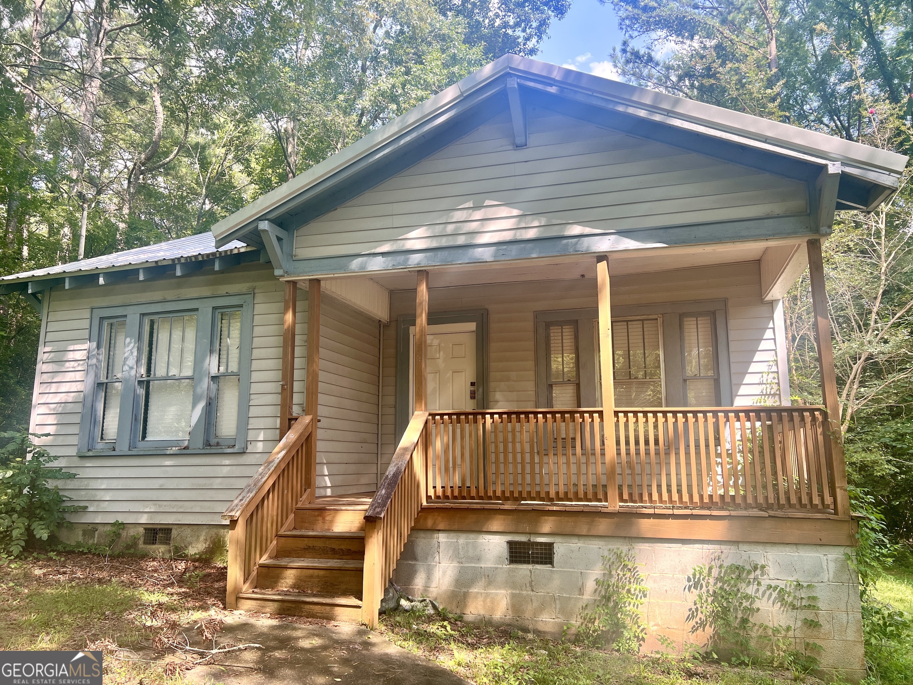 a view of a house with a small deck