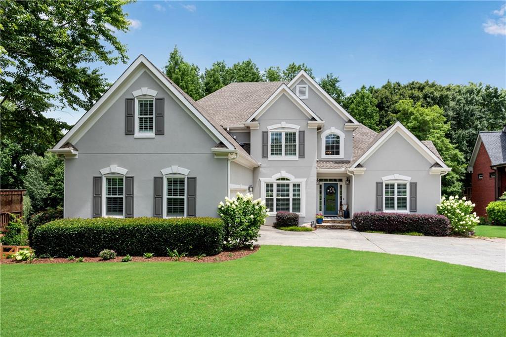 a front view of a house with a yard