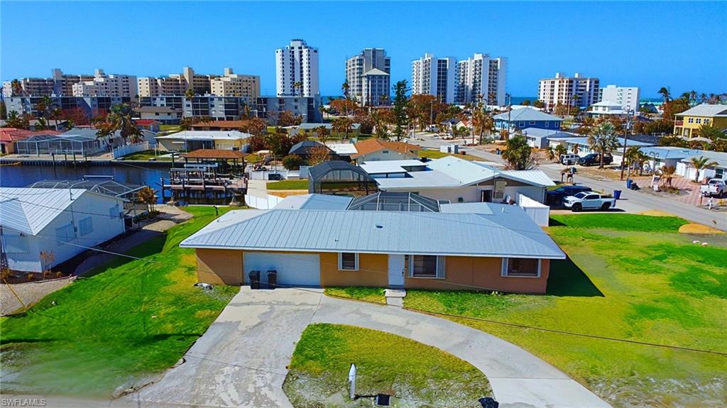 Birds eye view of property with a water view