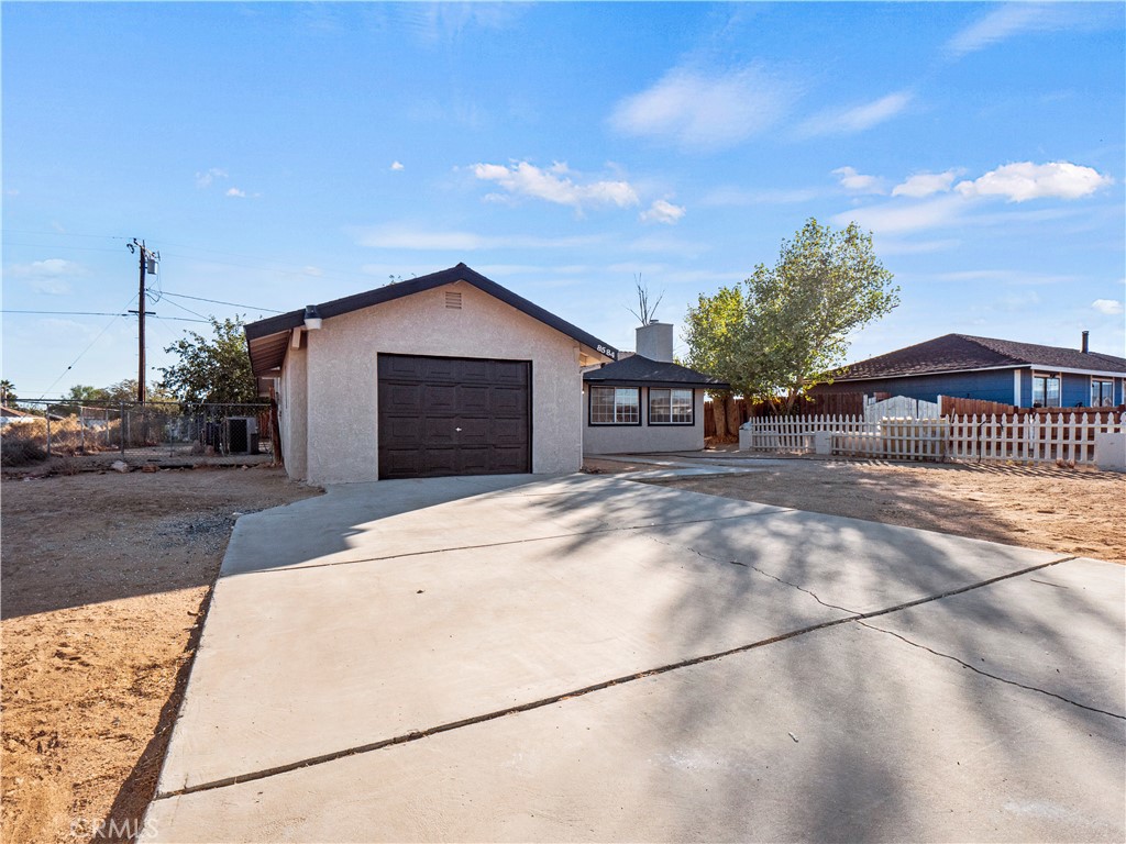 a view of a house with a yard and garage