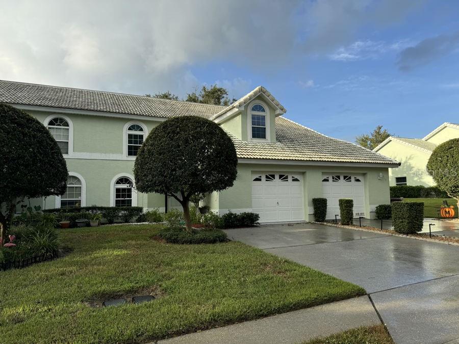 a front view of a house with a garden