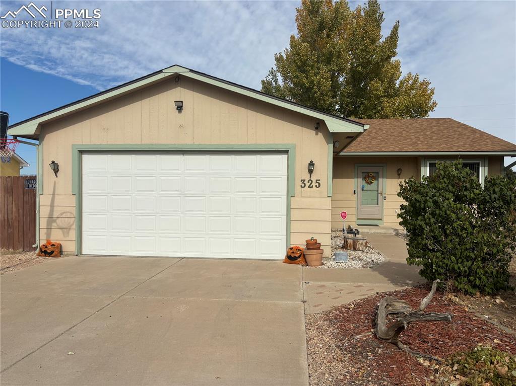 a view of a house with a yard and garage