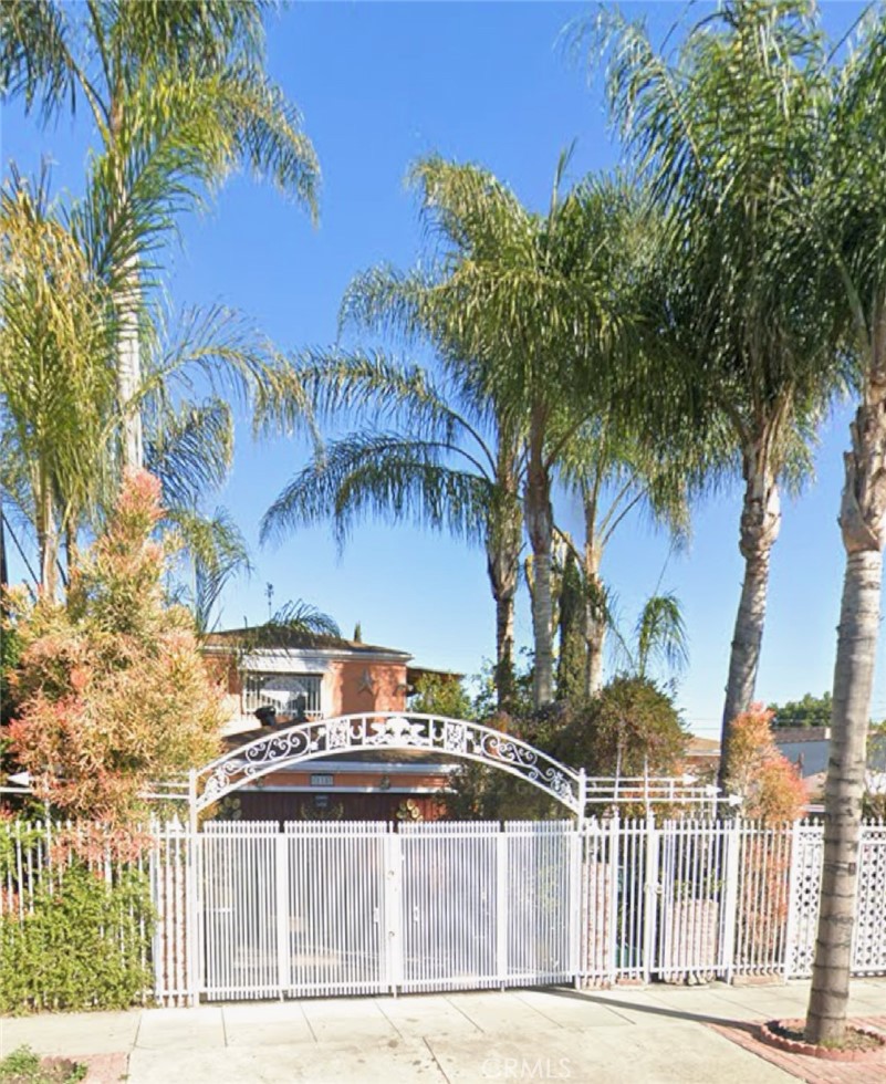 a front view of a building with palm trees