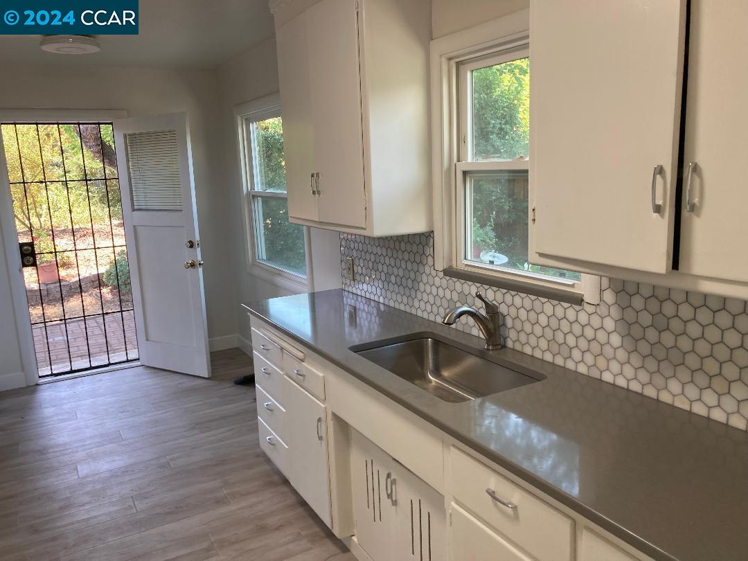 a kitchen with granite countertop a sink and a window