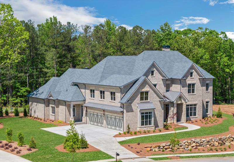 a aerial view of a house next to a yard