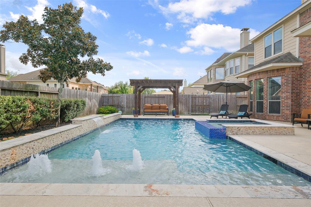 a view of a house with swimming pool and sitting area