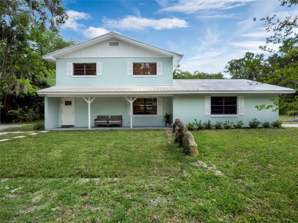 a front view of house with yard and seating area