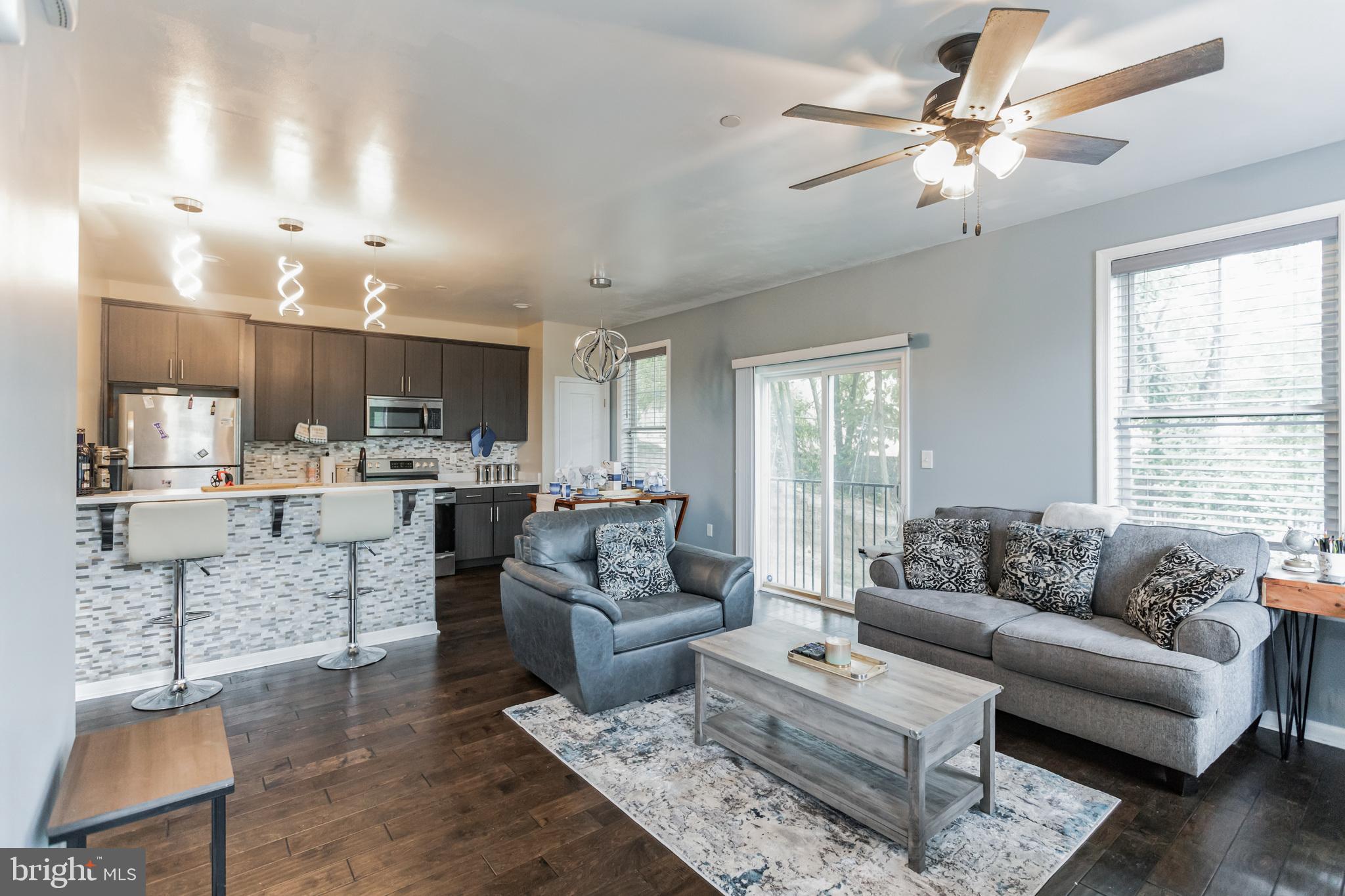 a living room with furniture and kitchen view