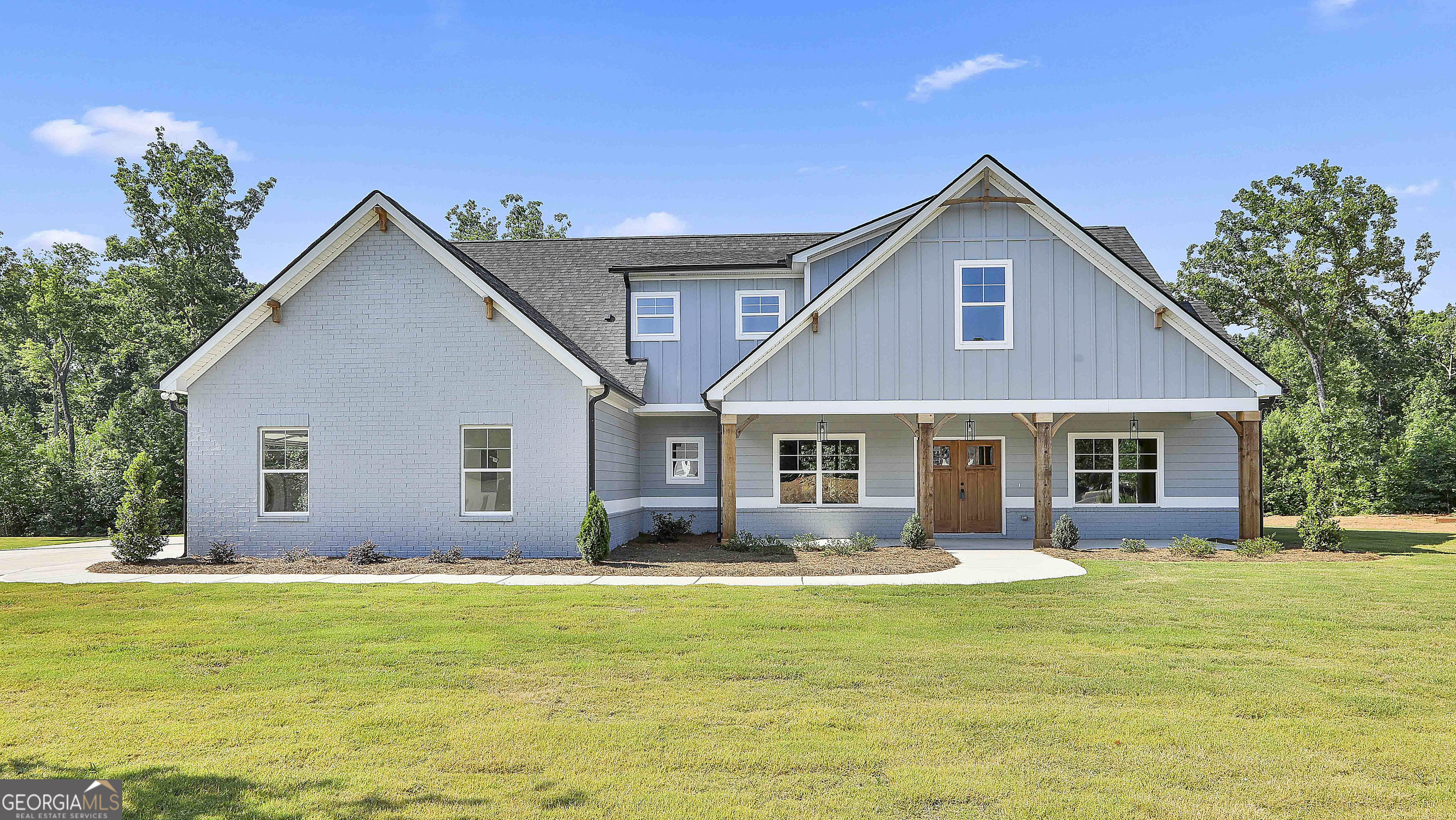 a front view of house with yard and green space