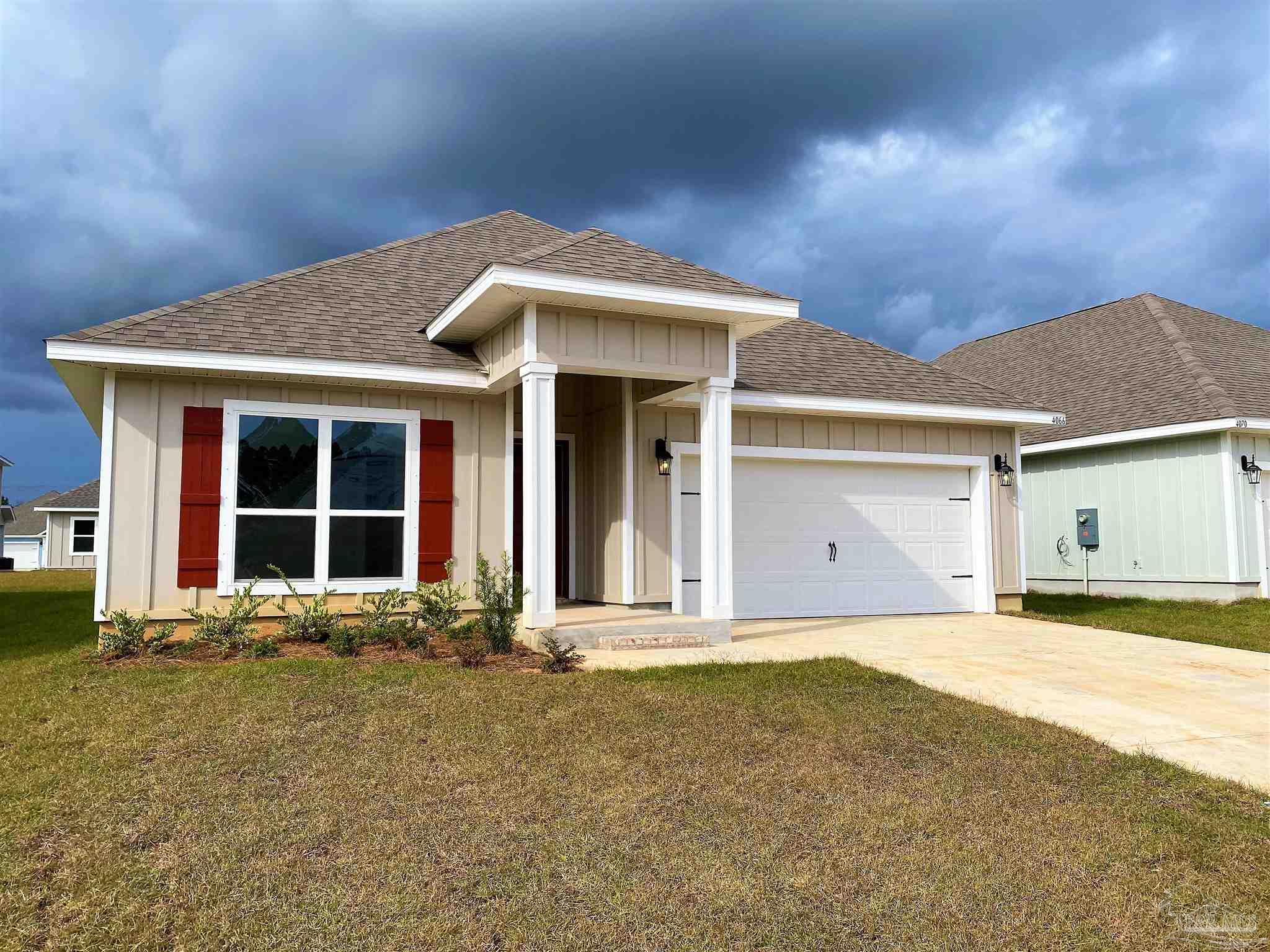 a front view of a house with a garden